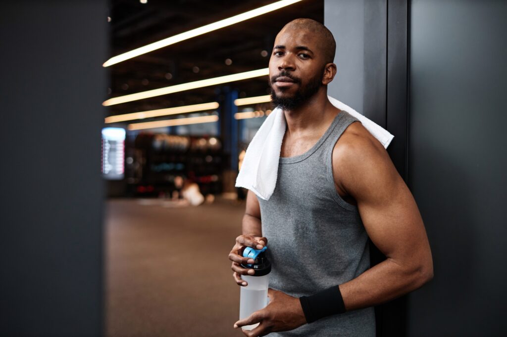 Muscular Black man looking at camera in gym