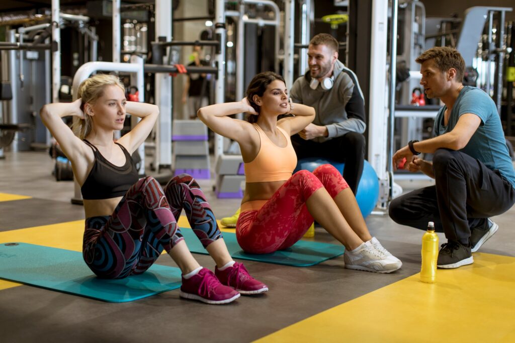 Young athlete doing stomach workout in modern gym